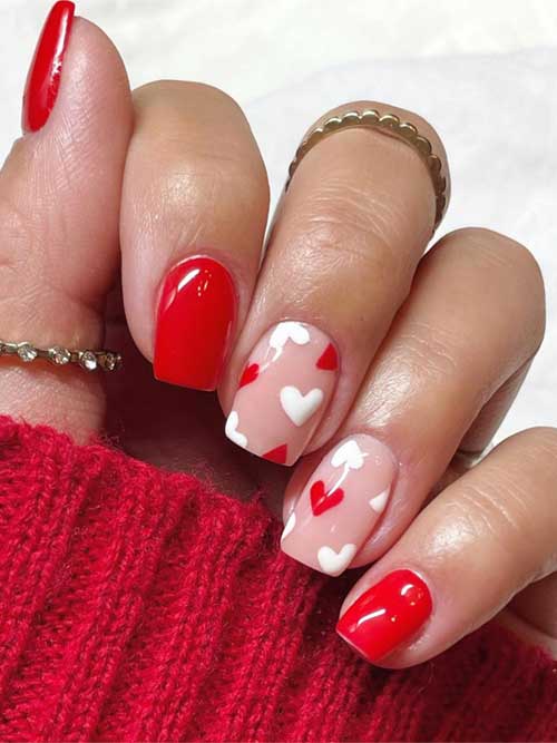 Short square red valentine press on nails featuring red and white heart designs for a chic look.