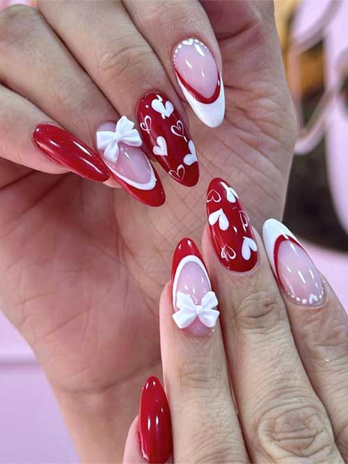 Valentine's-themed press-on nails in red and white with heart bows, medium almond shape for women.