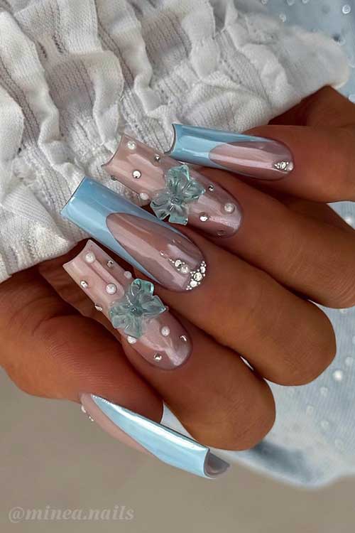 Elegant almond pastel blue and pink nails, featuring pearls, rhinestones, and floral designs for a fresh spring style.