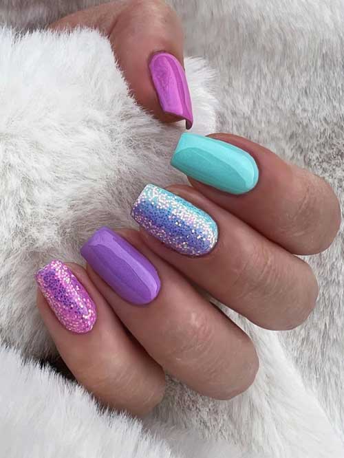 Playful pastel and glittery nail design with purple, turquoise, and pink hues, showcasing a vibrant seasonal energy.