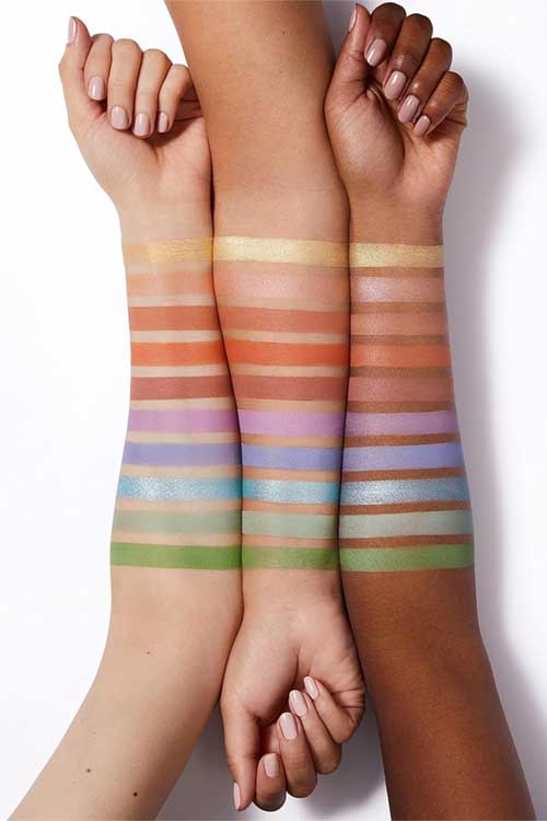 Swatches of the elf Perfect 10 Eyeshadow Palette showcasing a variety of vibrant colors on a skin tone background.